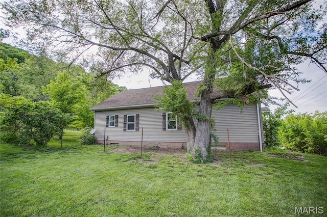 rear view of property with a yard