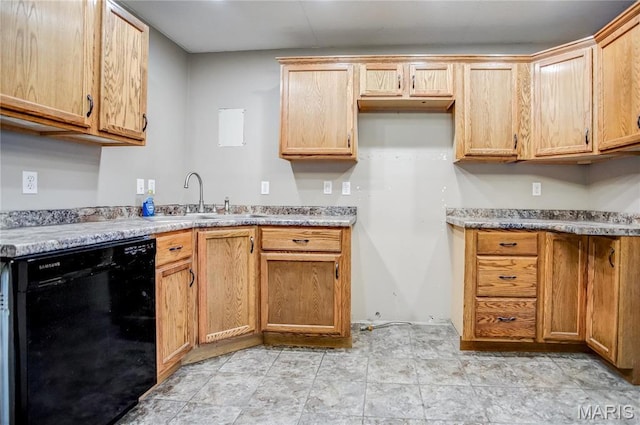 kitchen with black dishwasher, a sink, and light countertops