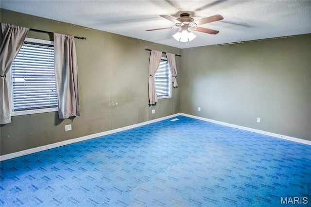 spare room featuring ceiling fan, baseboards, a textured ceiling, and carpet flooring