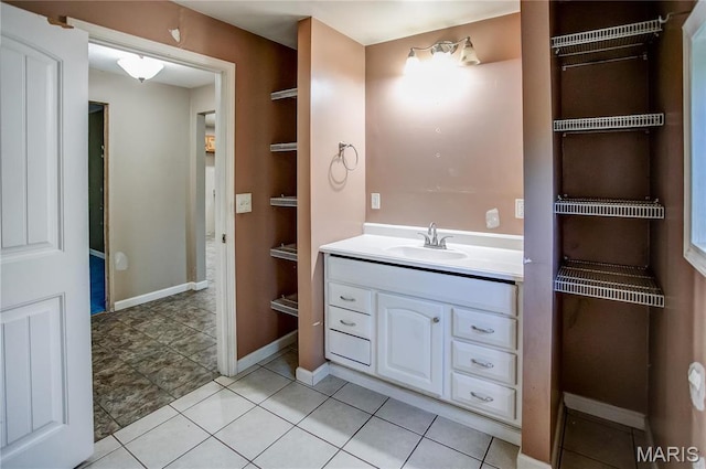 bathroom featuring vanity, tile patterned floors, and baseboards