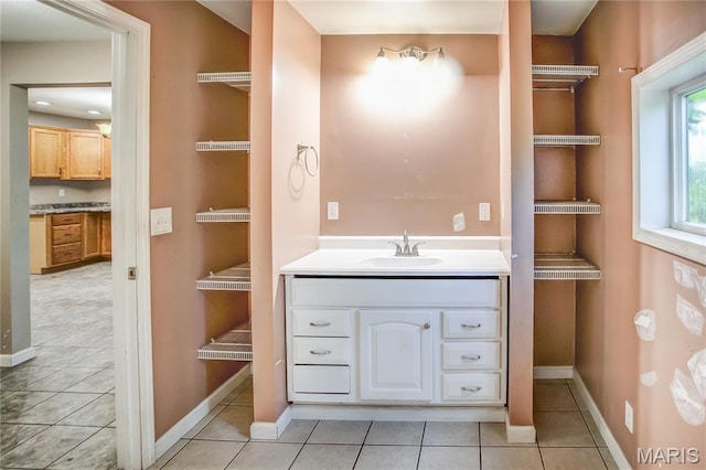 bathroom featuring baseboards, vanity, and tile patterned floors
