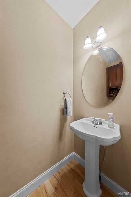 bathroom featuring wood finished floors and baseboards
