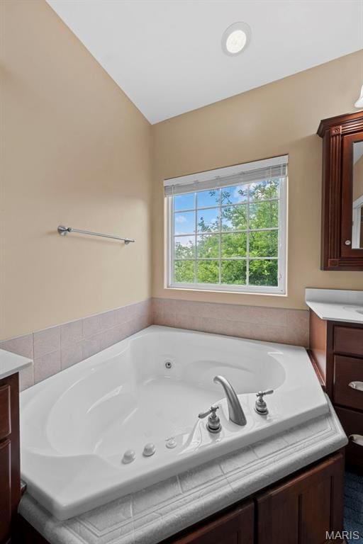 bathroom featuring vanity and a jetted tub
