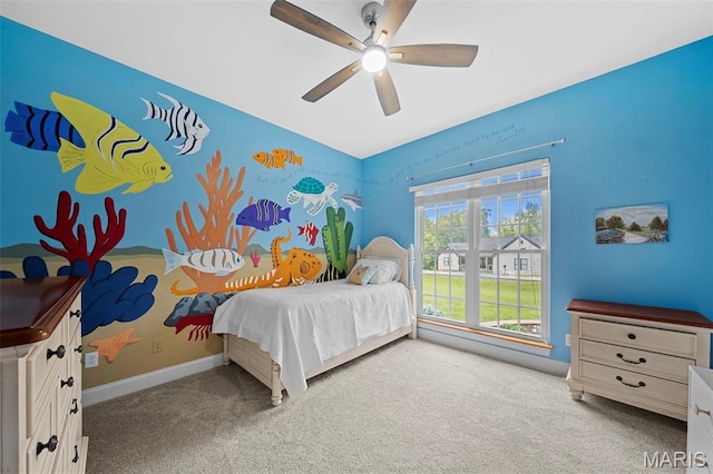 carpeted bedroom featuring baseboards and ceiling fan