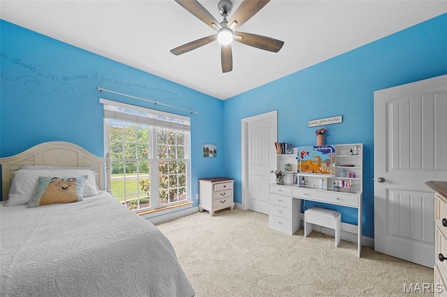 bedroom with light carpet and a ceiling fan