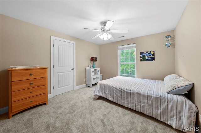 bedroom with carpet floors, baseboards, and a ceiling fan