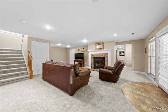 living room featuring carpet flooring, a fireplace, stairs, recessed lighting, and baseboards