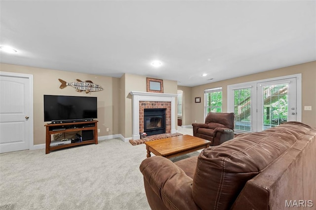 carpeted living area featuring baseboards, a fireplace, and recessed lighting