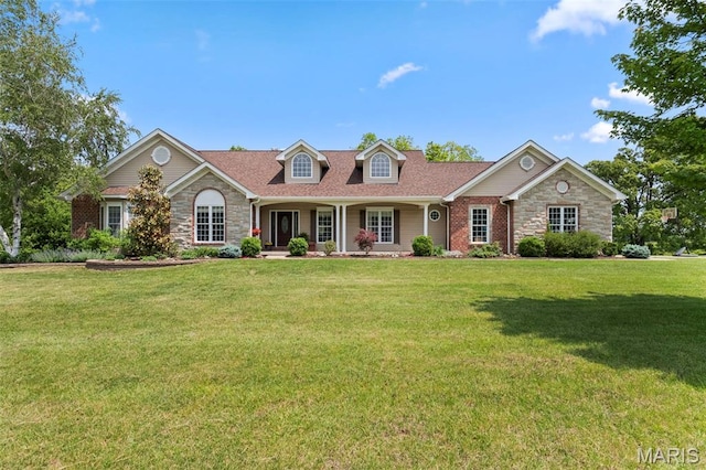 view of front of home with stone siding, a front lawn, and a porch