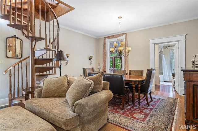 505 Thompson Ln, Arcadia, MO 63621 - dining area with stairs, a chandelier, crown molding, and wood finished floors