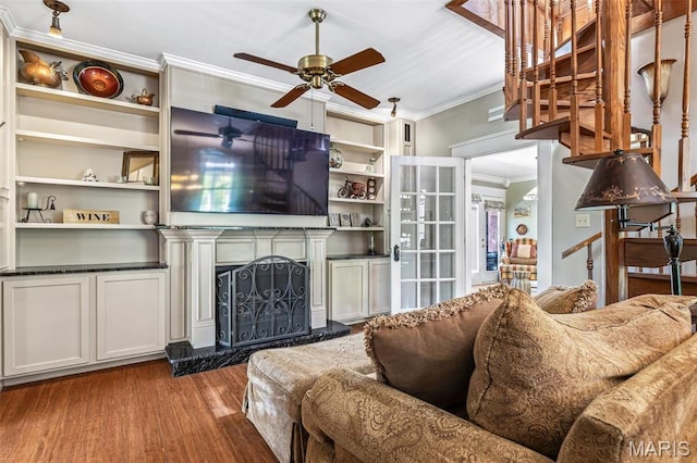 505 Thompson Ln, Arcadia, MO 63621 - living room with crown molding, a ceiling fan, wood finished floors, a fireplace with raised hearth, and built in shelves