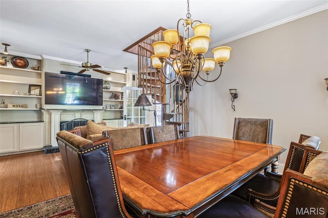 505 Thompson Ln, Arcadia, MO 63621 - dining area with crown molding, a chandelier, a ceiling fan, dark wood finished floors, and a fireplace