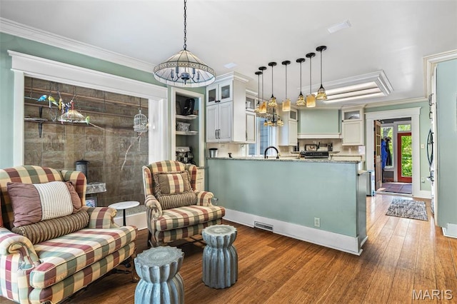 505 Thompson Ln, Arcadia, MO 63621 - living area featuring a chandelier, ornamental molding, and wood finished floors