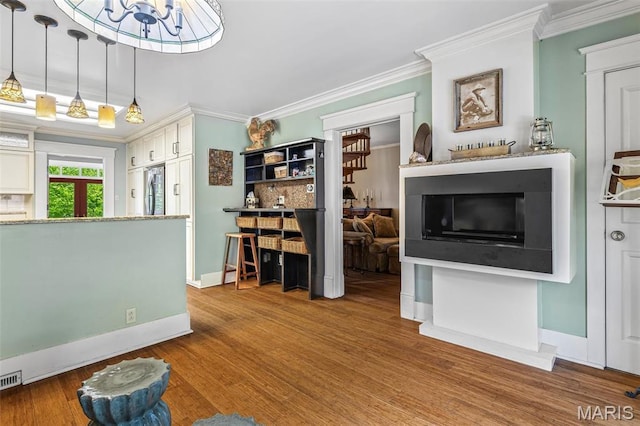 505 Thompson Ln, Arcadia, MO 63621 - living area featuring ornamental molding, wood finished floors, and a chandelier