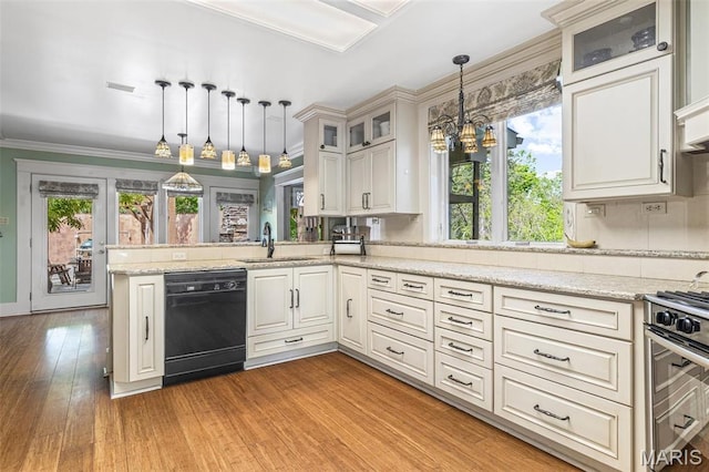 505 Thompson Ln, Arcadia, MO 63621 - kitchen featuring dishwasher, gas stove, light wood-type flooring, decorative light fixtures, and a peninsula