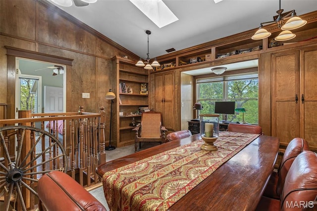 505 Thompson Ln, Arcadia, MO 63621 - carpeted dining room with lofted ceiling, a skylight, and wood walls
