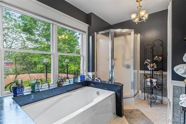 505 Thompson Ln, Arcadia, MO 63621 - bathroom with a shower stall, a garden tub, a chandelier, and a wainscoted wall