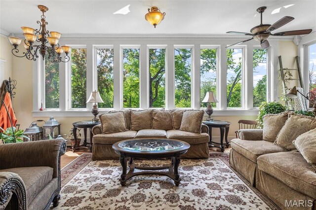 505 Thompson Ln, Arcadia, MO 63621 - living room featuring a ceiling fan, wood finished floors, crown molding, and a chandelier