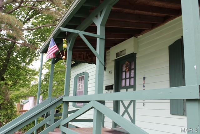 view of side of home featuring a porch