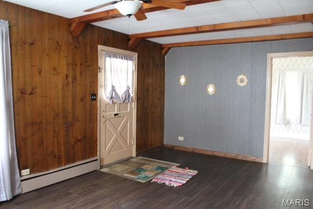 entryway with ceiling fan, beam ceiling, wood finished floors, wooden walls, and a baseboard radiator