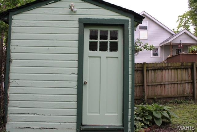 view of shed featuring fence