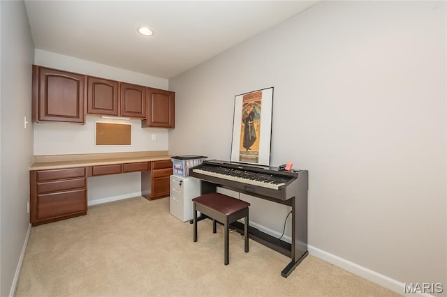 home office with light colored carpet, built in desk, baseboards, and recessed lighting