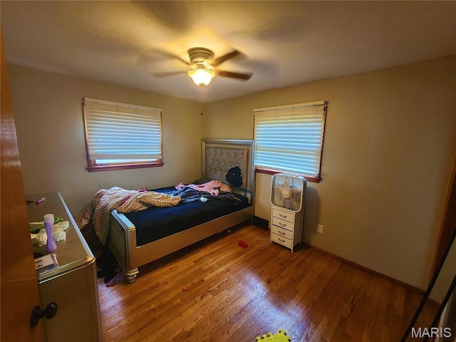 1437 Farmview Ave, Saint Louis, MO 63138 - bedroom with multiple windows, wood finished floors, ceiling fan, and baseboards
