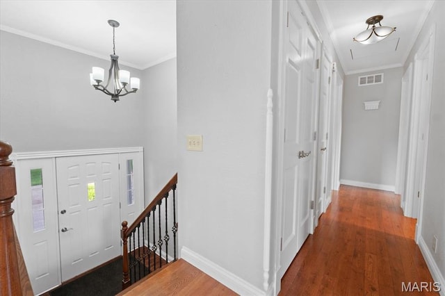 8316 D Rd, Waterloo, IL 62298 - entryway featuring wood finished floors, a chandelier, baseboards, and crown molding