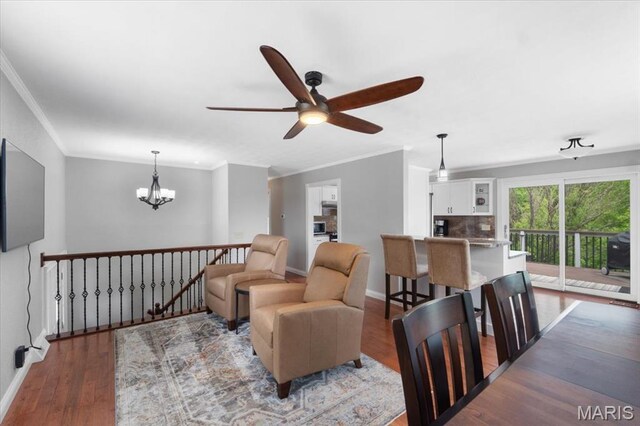 8316 D Rd, Waterloo, IL 62298 - living area with crown molding, a chandelier, a ceiling fan, wood finished floors, and baseboards