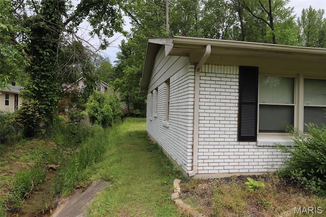 1507 Vine St, Poplar Bluff, MO 63901 - view of property exterior with brick siding and a lawn