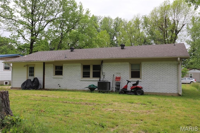 1507 Vine St, Poplar Bluff, MO 63901 - rear view of house with central AC, brick siding, and a yard