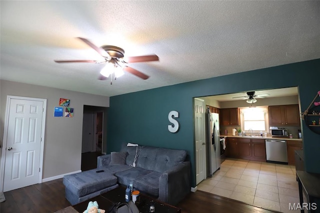 1507 Vine St, Poplar Bluff, MO 63901 - living room featuring a ceiling fan, light wood-style floors, and baseboards