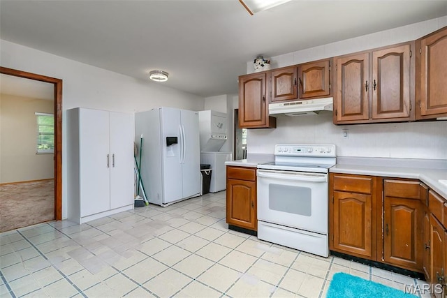 128 Cumberland Ave, Maryland Heights, MO 63043 - kitchen featuring white appliances, under cabinet range hood, light countertops, and brown cabinetry