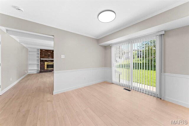 3009 Country Knoll Dr, Saint Charles, MO 63303 - empty room featuring wood finished floors, a fireplace, ornamental molding, baseboards, and a smoke detector