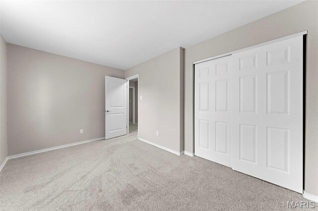 3009 Country Knoll Dr, Saint Charles, MO 63303 - unfurnished bedroom with carpet, a closet, and baseboards