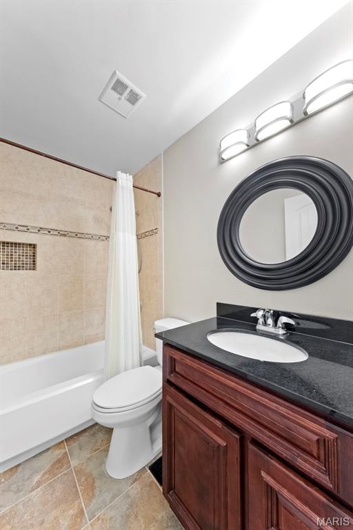 3009 Country Knoll Dr, Saint Charles, MO 63303 - bathroom with shower / tub combo, toilet, and vanity