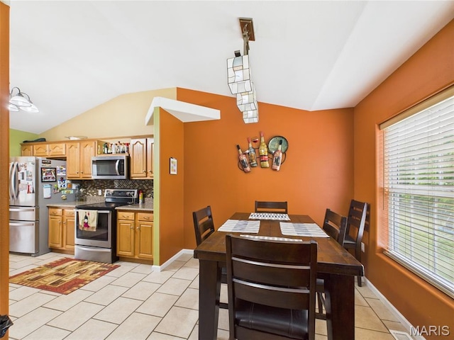 109 Locust Ct, Saint Robert, MO 65584 - dining area featuring light tile patterned floors, lofted ceiling, and baseboards