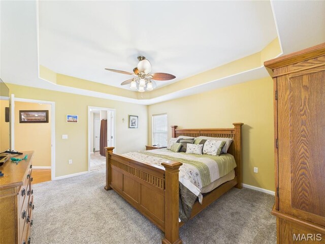 109 Locust Ct, Saint Robert, MO 65584 - bedroom with light carpet, a raised ceiling, ceiling fan, and baseboards