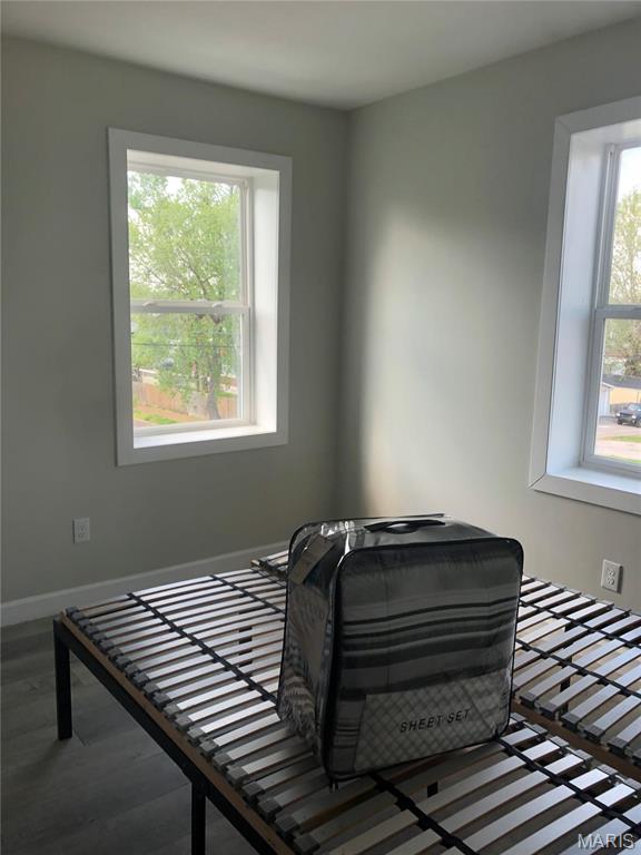 bedroom featuring baseboards and wood finished floors
