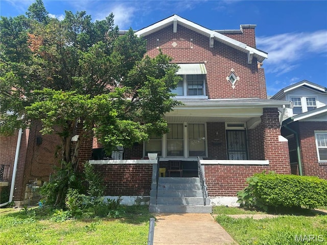view of front of house featuring covered porch and brick siding