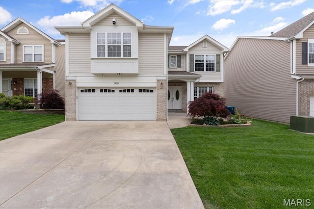 view of front of property featuring brick siding, driveway, an attached garage, and a front yard
