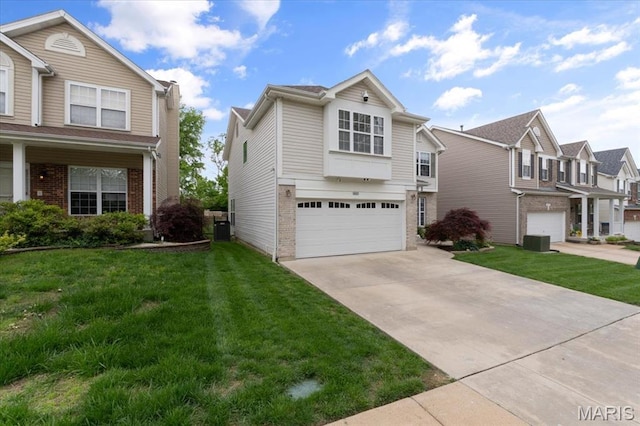 traditional-style home with an attached garage, brick siding, concrete driveway, and a front yard