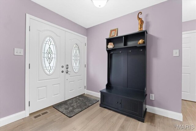 entryway featuring baseboards and light wood-style floors