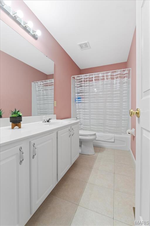 bathroom featuring toilet, tile patterned floors, and vanity