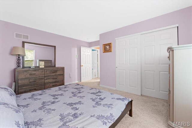 bedroom featuring a closet, carpet flooring, and baseboards