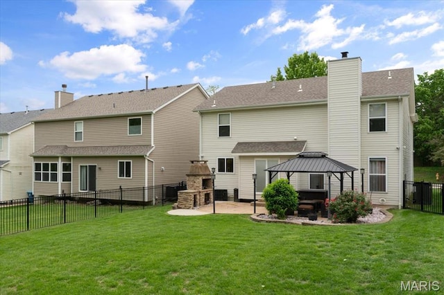 back of property featuring a fireplace, a gazebo, a patio, and a chimney