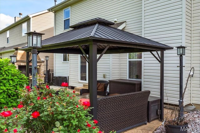 back of house featuring a gazebo, metal roof, and a standing seam roof