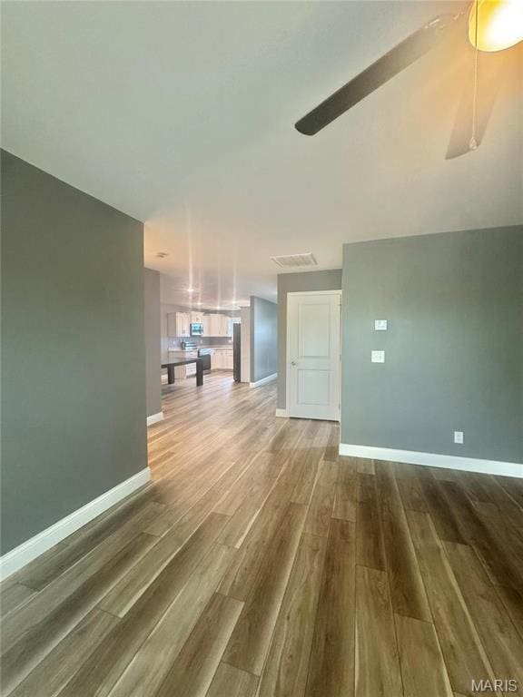 400 E Deerwood Drive 400 & 402, Jackson, MO 63755 - unfurnished living room featuring wood finished floors and a ceiling fan