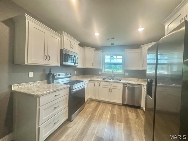 400 E Deerwood Drive 400 & 402, Jackson, MO 63755 - kitchen featuring stainless steel appliances, light wood-style flooring, white cabinetry, recessed lighting, and decorative light fixtures