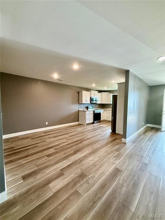 400 E Deerwood Drive 400 & 402, Jackson, MO 63755 - unfurnished living room featuring light wood finished floors and recessed lighting